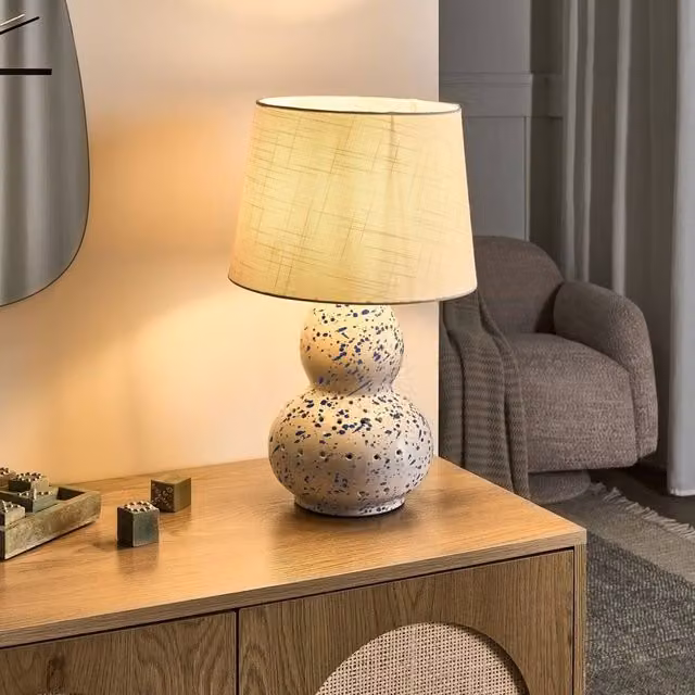 Wyld and Coco Modern White Ceramic Table Lamp with Blue Splatters and White Fabric Drum Shade – 1