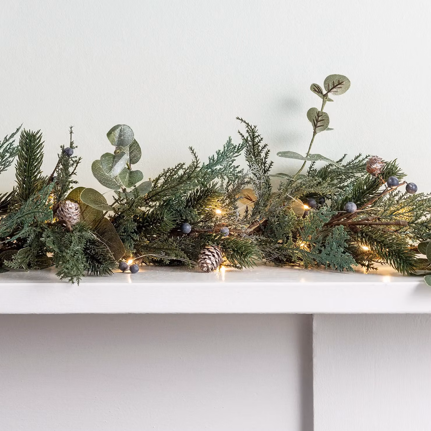 Lights4fun Pre Lit Berry and Pinecone Artificial Christmas Garland Decoration with White Micro LED Fairy Lights, Green and White – 1