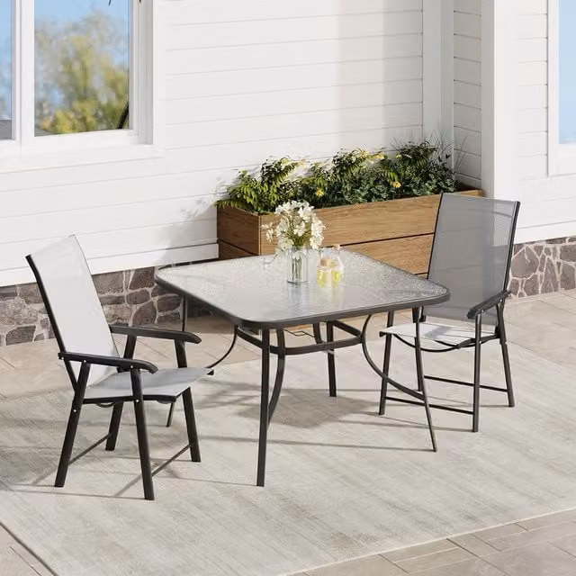 Komore Modern Outdoor Glass Dining Table and Folding Chairs Set in Black