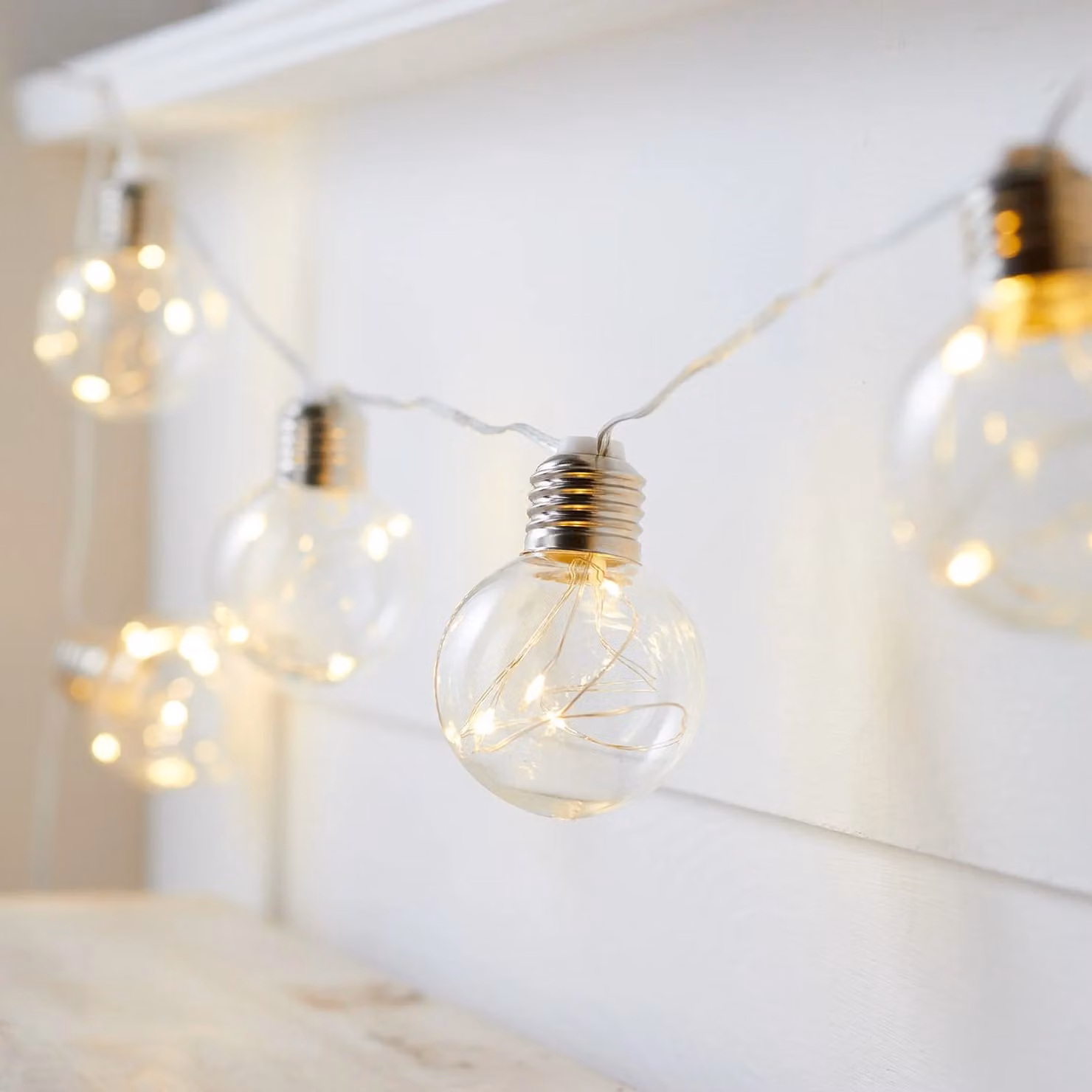 Lights4fun 10 Silver Sphere Micro Battery Festoon String Lights with Warm White Transparent Bulbs