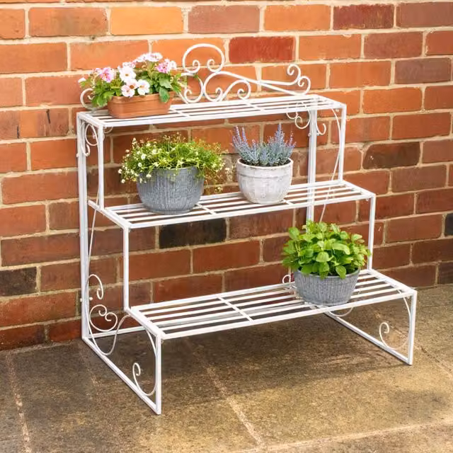 Melody Maison Three Tier White Lacquered Metal Plant Theatre Stand with Vintage Distressed Finish