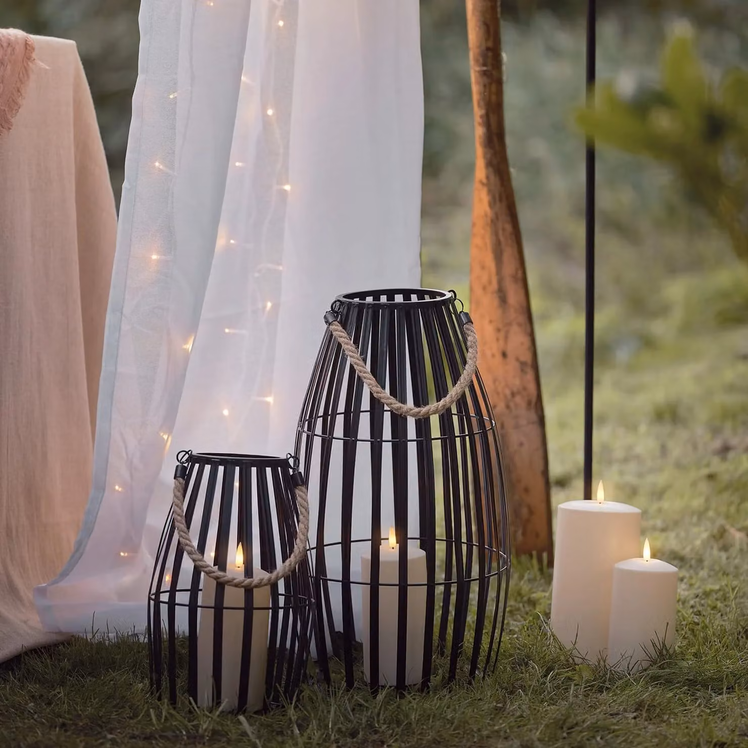 Lights4fun Set of 2 Black Metal Cage Waterproof Outdoor LED TruGlow Pillar Candle Lanterns with Timer and Flicker Effect – 1
