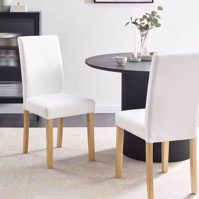 Wyld and Coco Set of 2 White Faux Leather Dining Chairs with Rubberwood Legs – 1