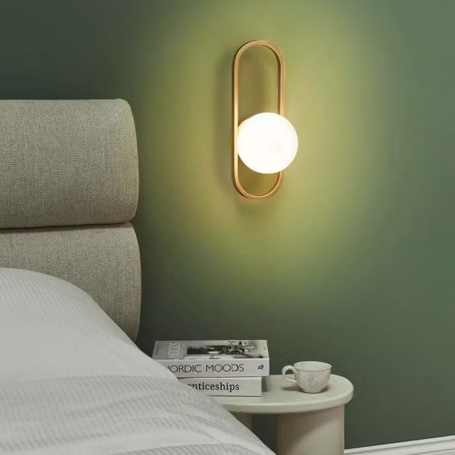 Wyld and Coco Gold Modern Oval Wall Lamp with Glass Shade and Metal Base