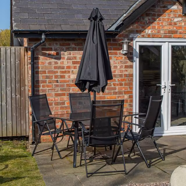 Samuel Alexander Modern 4 Person Rectangular Glass Top Patio Set in Black