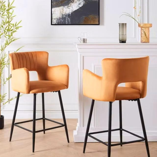 Wyld and Coco Set of 2 Orange Velvet Bar Chairs with Armrests and Cutout Back and Black Metal Frame