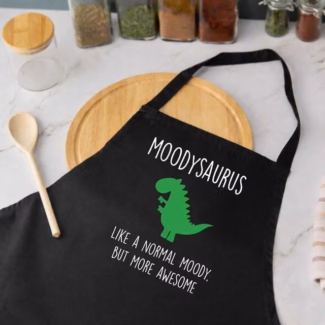 60 Second Makeover Moodysaurus Moody Dinosaur Apron in Black – 1