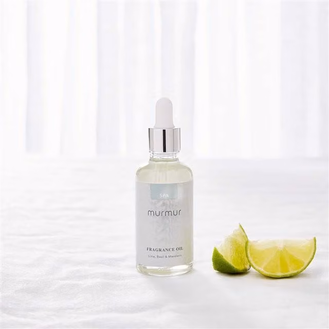 Murmur Spa Fragrance Oil in a Minimalist Round Glass Bottle with Fresh, Fruity and Spicy Notes