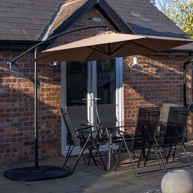 Samuel Alexander 6 Seater Glass Dining Table and Chairs Set with Beige Banana Parasol and Base in Black
