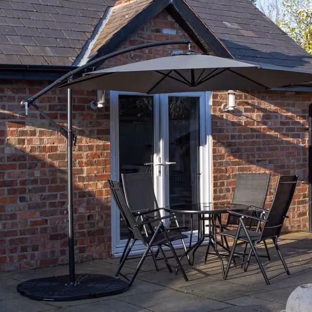 Samuel Alexander 4 Person Glass Top Dining Set with Grey Banana Parasol and Base in Black