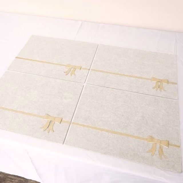 Melody Maison Set of 4 Beige Rectangular Felt Placemats with Champagne Gold Bow