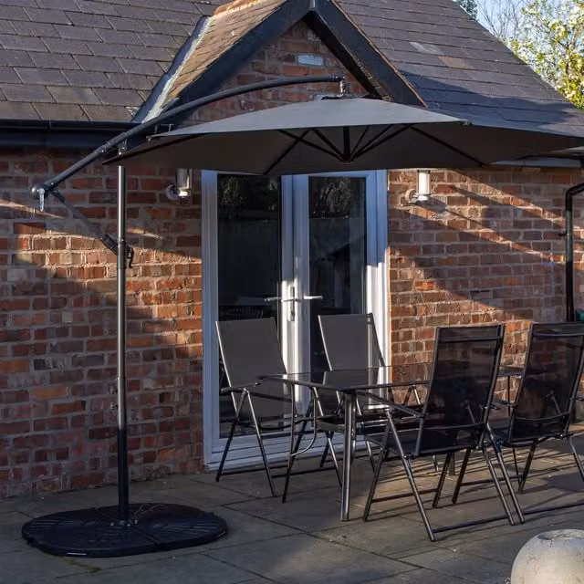 Samuel Alexander 4 Seater Glass Top Dining Set with Grey Banana Parasol and Base in Black