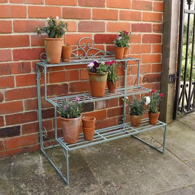 Melody Maison Three Tier Lacquered Metal Plant Theatre Stand in Sage Green and Dark Blue