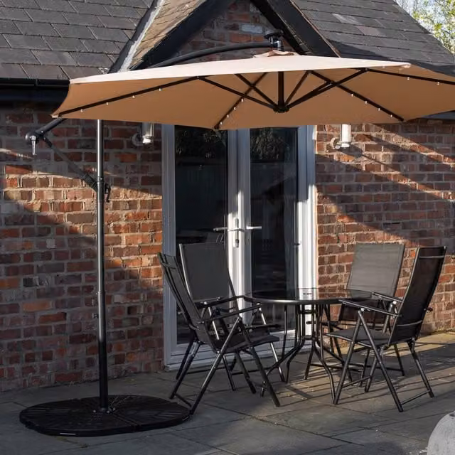 Samuel Alexander 4 Person Round Glass Top Garden Dining Set with Beige Parasol and Base in Black