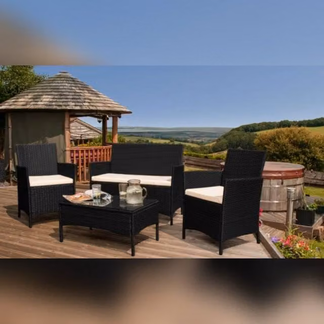 Comfy Living Ltd 4-Piece Black Polyrattan Garden Patio Furniture Set with Upholstered Cushions, 2-Seater Sofa, 2 Armchairs and Glass Coffee Table