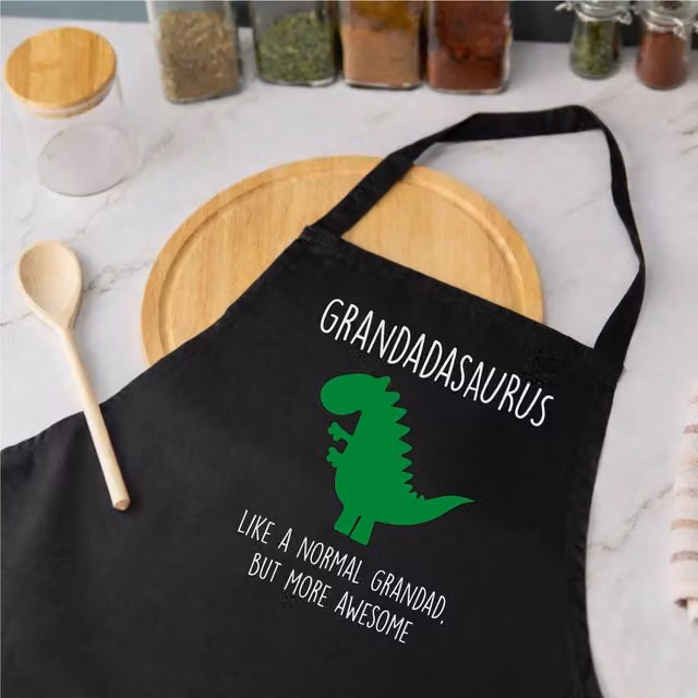 60 SECOND MAKEOVER Men's Grandad Dinosaur Apron in Black – 1