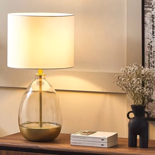 Wyld and Coco Table Lamp with Transparent Glass Base, Gold Accents and White Fabric Shade