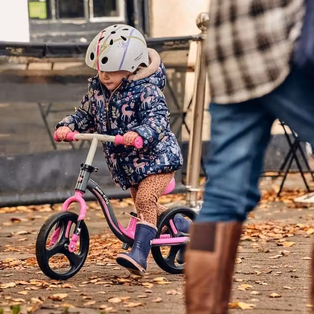 Ride-ezy Go glo balance bike in pink and silver with height adjustment and light and sound features
