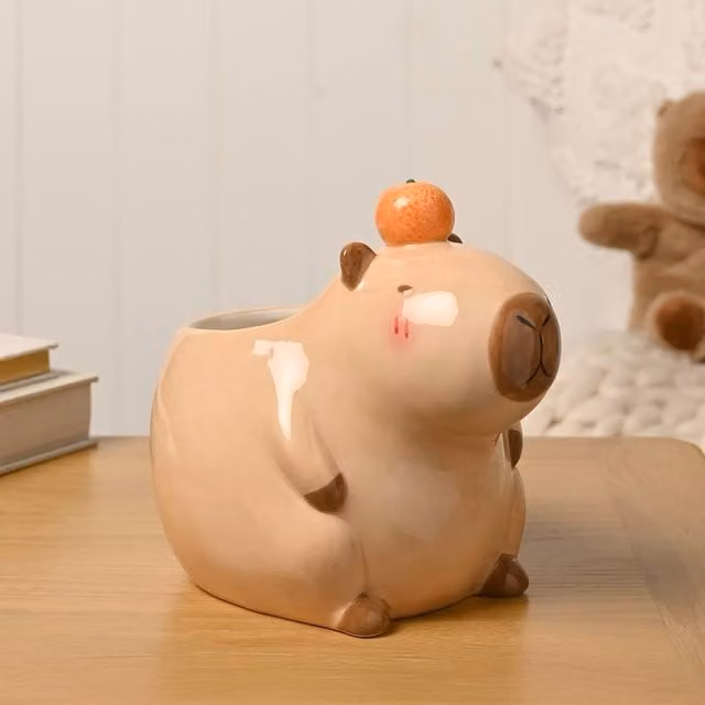 The Feel Good Club Capybara Ceramic Plant Pot in Brown and Orange