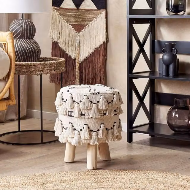 Wyld and Coco Beige Boho Cylindrical Footstool with Black Cotton Knit Tassels and Wood Frame