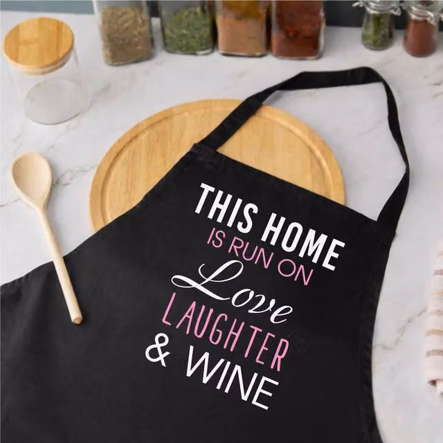 60 Second Makeover Limited This Home Is Run On Love Laughter And Wine Apron in Black – 1