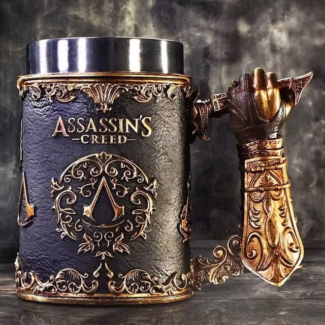 Nemesis Now Assassin's Creed Through the Ages Resin Tankard Mug in Gold and Black, Height: 15.5 cm