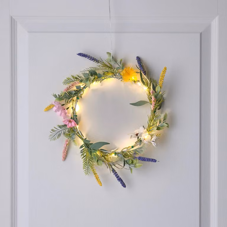 Lights4fun 20cm Pre-Lit Artificial Lavender Wildflower Foliage Wreath in Pink and Multicolour with 16 Warm White LEDs