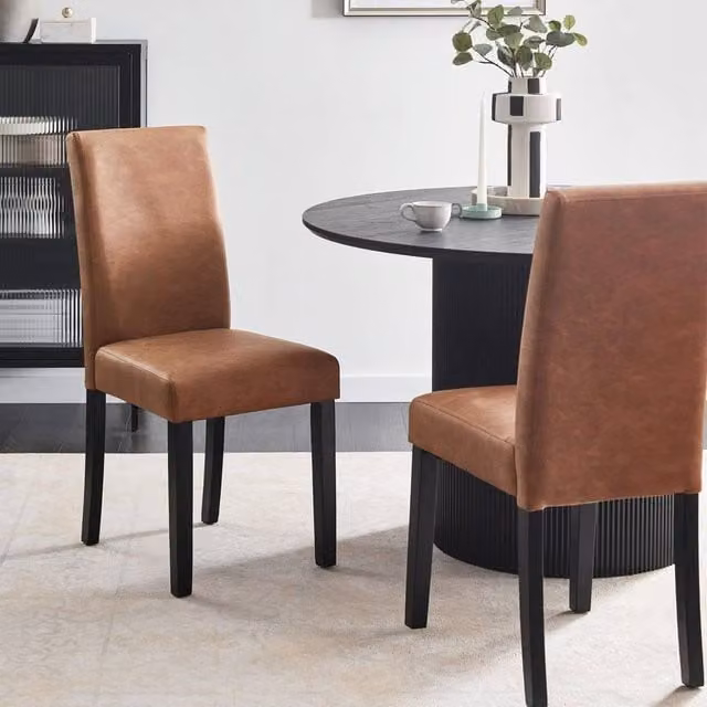 Wyld and Coco Set of 2 Brown Faux Leather Dining Chairs with Solid Rubberwood Legs – 1