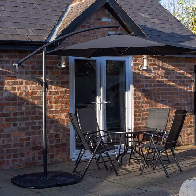 Samuel Alexander 4 Person Glass Table and Chairs Set with Black Banana Parasol and Base