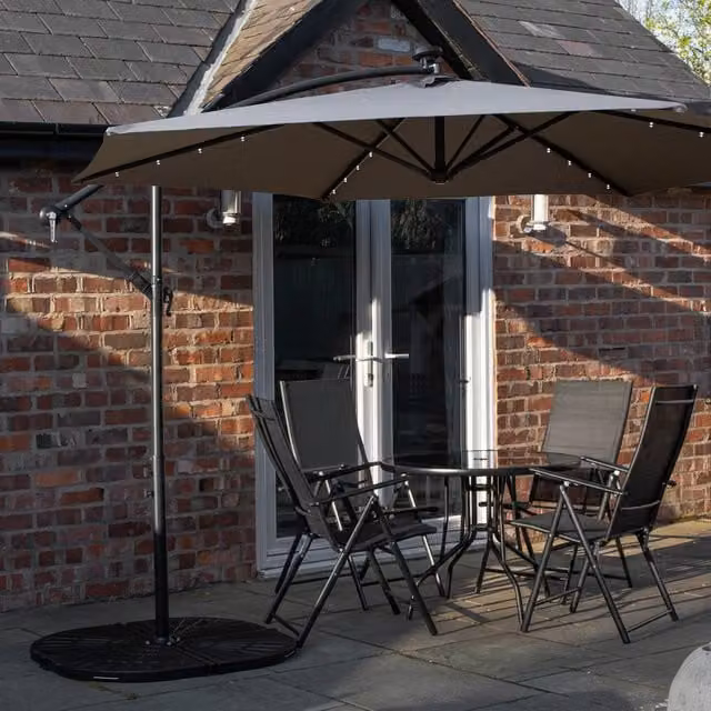 Samuel Alexander 4 Person Round Glass Top Garden Dining Set with Grey Banana Lit Parasol and Base in Black