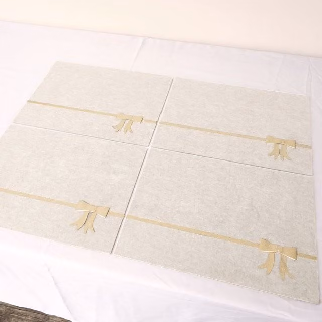 Melody Maison Set of 4 Beige Rectangular Felt Placemats with Champagne Gold Bow