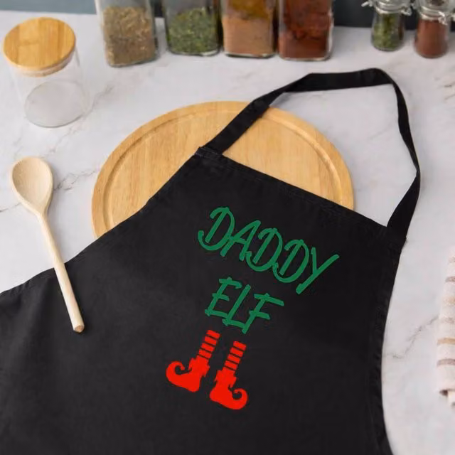 60 SECOND MAKEOVER Men's Daddy Elf Apron in Black – 1