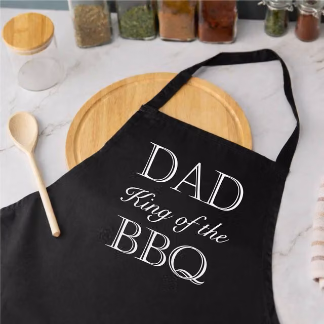 60 SECOND MAKEOVER Men's Dad King of the BBQ Apron in Black – 1